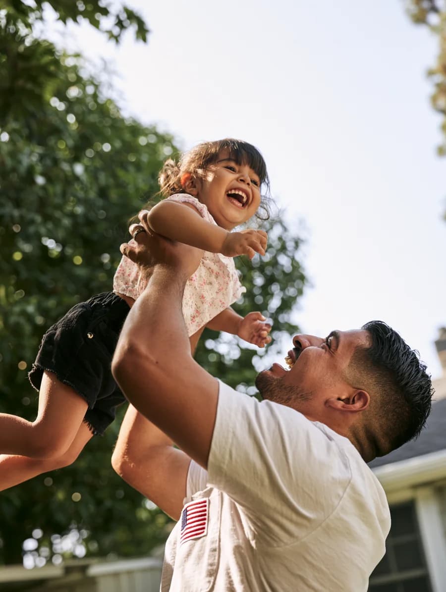 Father lifting child outdoors